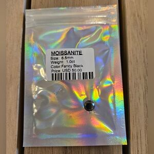Fancy black moissanite gemstone with a size of 6.5mm, a weight of 1.0 carat.